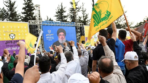 Hezbollah leader Sayyed Hassan Nasrallah is seen on a screen during election rallies a few days before the general election in Baalbeck, Lebanon, May 1, 2018 - Sputnik International