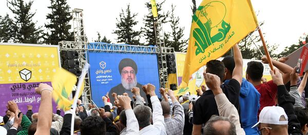 Hezbollah leader Sayyed Hassan Nasrallah is seen on a screen during election rallies a few days before the general election in Baalbeck, Lebanon, May 1, 2018 - Sputnik International