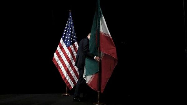 A staff member removes the Iranian flag from the stage after a group picture with foreign ministers and representatives of the U.S., Iran, China, Russia, Britain, Germany, France and the European Union during the Iran nuclear talks at the Vienna International Center in Vienna, Austria July 14, 2015 - Sputnik International