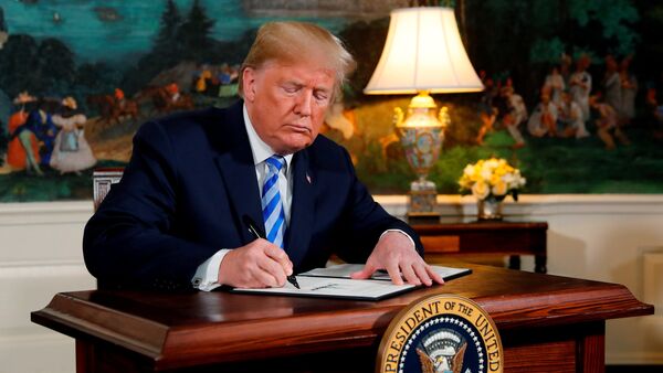 U.S. President Donald Trump signs a proclamation declaring his intention to withdraw from the JCPOA Iran nuclear agreement in the Diplomatic Room at the White House in Washington, U.S., May 8, 2018 - Sputnik International