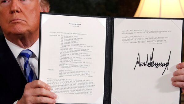U.S. President Donald Trump holds up a proclamation declaring his intention to withdraw from the JCPOA Iran nuclear agreement after signing it in the Diplomatic Room at the White House in Washington, U.S. May 8, 2018 - Sputnik International