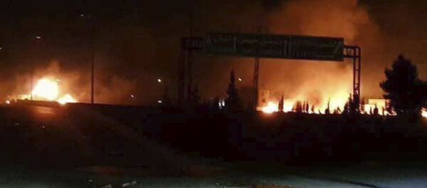This photo released on Wednesday, May 9, 2018, by the Syrian official news agency SANA, shows flames rising after an attack in an area known to have numerous Syrian army military bases, in Kisweh, south of Damascus, Syria This photo released on Wednesday, May 9, 2018, by the Syrian official news agency SANA, shows flames rising after an attack in an area known to have numerous Syrian army military bases, in Kisweh, south of Damascus, Syria - Sputnik International