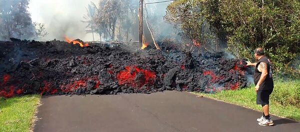In this photo taken from video an unidentified man gets close to a lava flow advancing down a road in the Leilani Estates subdivision near Pahoa on the island of Hawaii Monday, May 7, 2018 In this photo taken from video an unidentified man gets close to a lava flow advancing down a road in the Leilani Estates subdivision near Pahoa on the island of Hawaii Monday, May 7, 2018 - Sputnik International