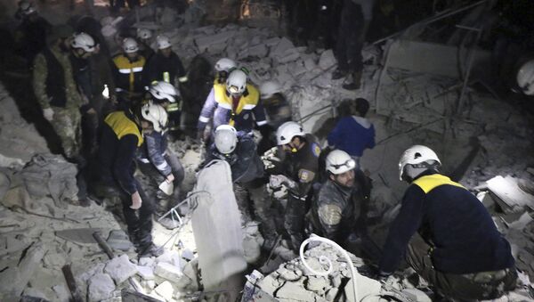 This photo provided on Sunday, Jan. 7, 2018 by the Syrian Civil Defense White Helmets, which has been authenticated based on its contents and other AP reporting, shows Civil Defense workers inspecting a damages building after a bombing that targeted the office of Ajnad al-Koukaz, a militant group consisting of foreign fighters mostly from the Caucuses and Russia, in Idlib, Syria - Sputnik International