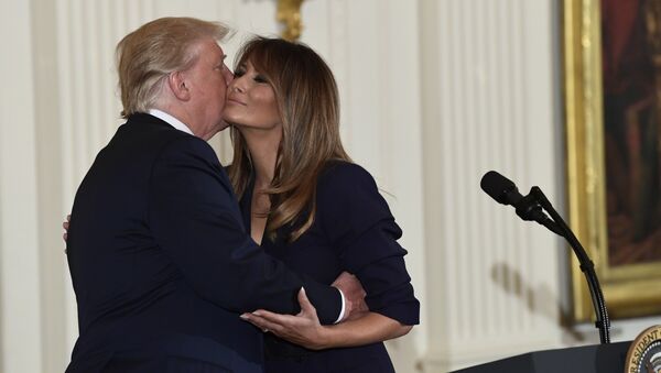 President Donald Trump kisses first lady Melania Trump during a celebration of military mothers and spouses event in the East Room of the White House in Washington, Wednesday, May 9, 2018 - Sputnik International