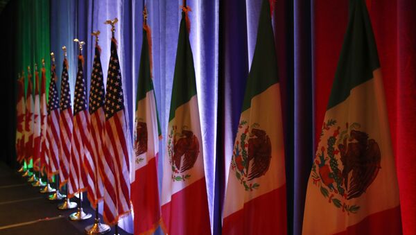 FILE - In this Aug. 16, 2017 file photo, the national flags of Canada, from left, the U.S. and Mexico, are lit by stage lights before a news conference, at the start of North American Free Trade Agreement renegotiations in Washington D.C. Mexico appears to be preparing for the worst as the fourth round of talks open in Washington D.C, Wednesday, Oct. 11, 2017 - Sputnik International