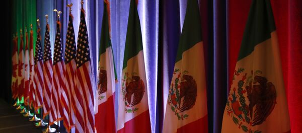 FILE - In this Aug. 16, 2017 file photo, the national flags of Canada, from left, the U.S. and Mexico, are lit by stage lights before a news conference, at the start of North American Free Trade Agreement renegotiations in Washington D.C. Mexico appears to be preparing for the worst as the fourth round of talks open in Washington D.C, Wednesday, Oct. 11, 2017 - Sputnik International