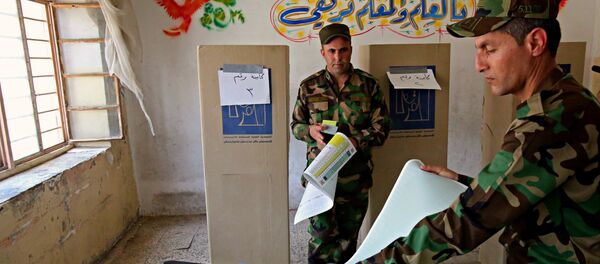 Iraqi soldiers prepare to cast their votes in early voting for Iraq's security forces, prisoners and hospital patients ahead of Saturday's national parliamentary elections, in Baghdad, Iraq, Thursday, May 10, 2018. - Sputnik International