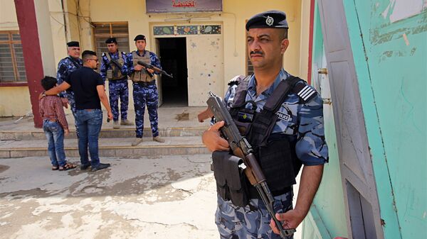 In this Wednesday, May 9, 2018 photo, Iraqi security forces guard a polling station in Baghdad, Iraq - Sputnik International