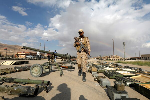 (File) A Syrian Army soldier holds his weapon, as he walks next to others that belonged to rebels from Eastern Qalamoun, after they handed them over, at the town of Dumayr, Damascus, Syria April 22, 2018 (File) A Syrian Army soldier holds his weapon, as he walks next to others that belonged to rebels from Eastern Qalamoun, after they handed them over, at the town of Dumayr, Damascus, Syria April 22, 2018 - Sputnik International