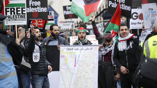 (File) Protesters hold up a map along with Palestinian flags and placards during a demonstration on Whitehall opposite Downing Street in central London on April 7, 2018 in support of the Palestianians in the Gaza Strip - Sputnik International