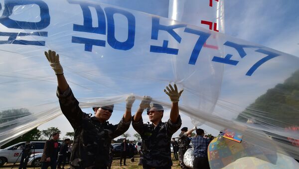 (File) South Korean activists fill gas into a large balloon to launch anti-Pyongyang leaflets into the air at a field near the Demilitarized zone dividing the two Koreas in the border city of Paju on April 29, 2016 - Sputnik International