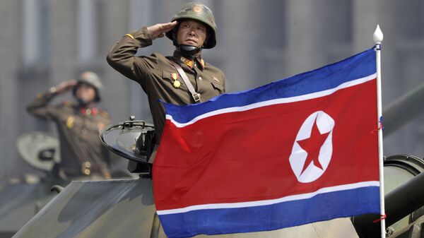 In this Saturday, April 15, 2017, file photo, a North Korean national flag flutters as soldiers in tanks salute to North Korean leader Kim Jong Un during a military parade in Pyongyang, North Korea to celebrate the 105th birth anniversary of Kim Il Sung, the country's late founder and grandfather of the current ruler - Sputnik International