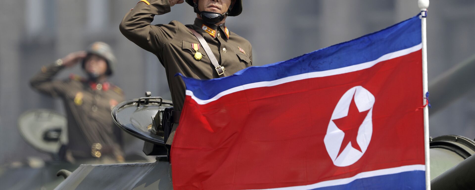 In this Saturday, April 15, 2017, file photo, a North Korean national flag flutters as soldiers in tanks salute to North Korean leader Kim Jong Un during a military parade in Pyongyang, North Korea to celebrate the 105th birth anniversary of Kim Il Sung, the country's late founder and grandfather of the current ruler - Sputnik International, 1920, 28.12.2022