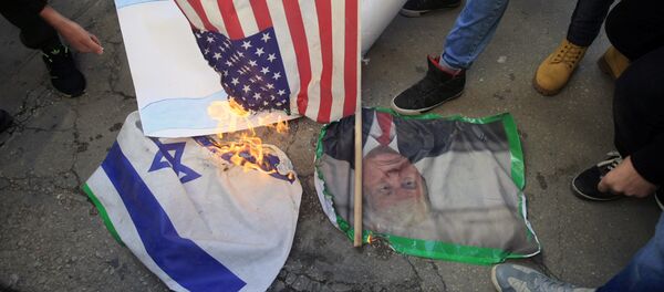 Lebanese and Palestinians students, burn a picture of U S. President Donald Trump, an American flag and an Israeli flag, as they take part in a protest at the Lebanese University, in the southern port city of Sidon, Lebanon, Thursday, Dec. 7, 2017, against U.S. President Donald Trump's decisions to recognize Jerusalem as the capital of Israel Lebanese and Palestinians students, burn a picture of U S. President Donald Trump, an American flag and an Israeli flag, as they take part in a protest at the Lebanese University, in the southern port city of Sidon, Lebanon, Thursday, Dec. 7, 2017, against U.S. President Donald Trump's decisions to recognize Jerusalem as the capital of Israel - Sputnik International
