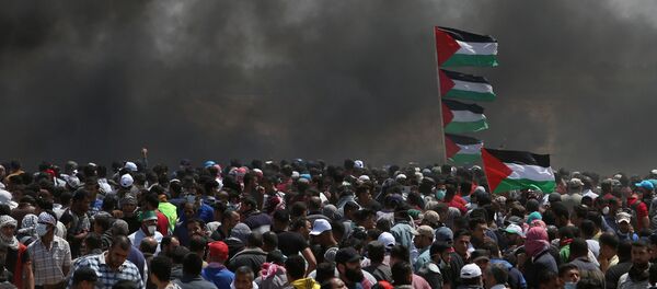 Palestinian demonstrators gather during a protest against U.S. embassy move to Jerusalem and ahead of the 70th anniversary of Nakba, at the Israel-Gaza border in the southern Gaza Strip May 14, 2018 Palestinian demonstrators gather during a protest against U.S. embassy move to Jerusalem and ahead of the 70th anniversary of Nakba, at the Israel-Gaza border in the southern Gaza Strip May 14, 2018 - Sputnik International