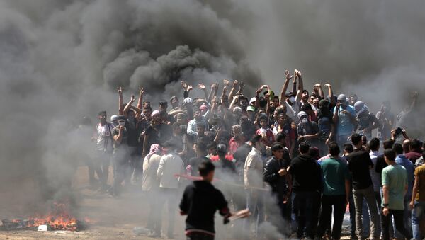 Palestinian demonstrators burn tyres near the Gaza-Israel border, east of Gaza City, as Palestinians readied for protests over the inauguration of the US embassy following its controversial move to Jerusalem on May 14, 0218 - Sputnik International