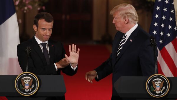 French President Emmanuel Macron waves to someone in the crowd as he and U.S. President Donald Trump conclude their joint news conference in the East Room of the White House in Washington, U.S., April 24, 2018 - Sputnik International