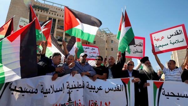 Palestinians, among them Adnan Husseini (3-rd R), the Palestinian Authority-appointed mayor of Jerusalem, participate in protest against the opening of the new U.S. embassy in Jerusalem, in Jerusalem May 14, 2018. Banner reads in Arabic Jerusalem Arab, Palestinian, Islamic and Christian and No to the Moving of the American Embassy. - Sputnik International
