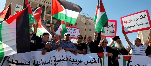 Palestinians, among them Adnan Husseini (3-rd R), the Palestinian Authority-appointed mayor of Jerusalem, participate in protest against the opening of the new U.S. embassy in Jerusalem, in Jerusalem May 14, 2018. Banner reads in Arabic Jerusalem Arab, Palestinian, Islamic and Christian and No to the Moving of the American Embassy. - Sputnik International