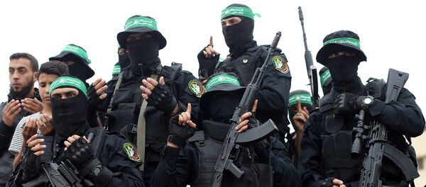 Palestinian Hamas militants attend the funeral of their comrades who were killed in an explosion, in the central Gaza Strip May 6, 2018 - Sputnik International