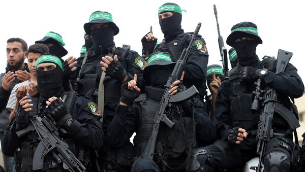 Palestinian Hamas militants attend the funeral of their comrades who were killed in an explosion, in the central Gaza Strip May 6, 2018 - Sputnik International
