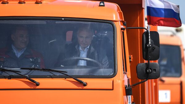 Russian President Vladimir Putin drives a Kamaz truck on the newly opened motor road section of the Kerch Strait (Crimean) Bridge - Sputnik International