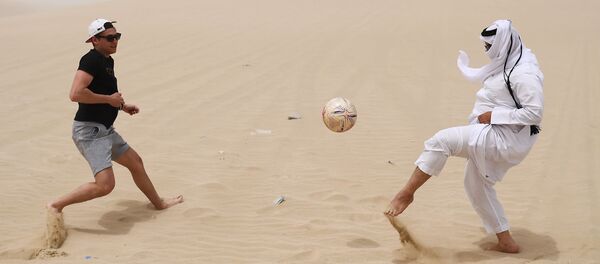 Playing football in the desert of Khor Al Adaid, Doha, State of Qatar. Playing football in the desert of Khor Al Adaid, Doha, State of Qatar. - Sputnik International