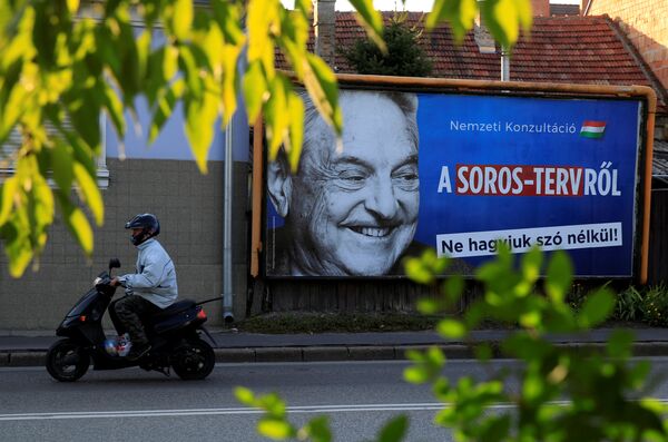 A man rides his moped past a government billboard displaying George Soros in monochrome next to a message urging Hungarians to take part in a national consultation about what it calls a plan by the Hungarian-born financier to settle a million migrants in Europe per year, in Szolnok, Hungary, October 2, 2017 A man rides his moped past a government billboard displaying George Soros in monochrome next to a message urging Hungarians to take part in a national consultation about what it calls a plan by the Hungarian-born financier to settle a million migrants in Europe per year, in Szolnok, Hungary, October 2, 2017 - Sputnik International