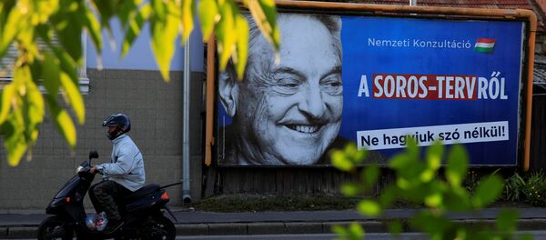 A man rides his moped past a government billboard displaying George Soros in monochrome next to a message urging Hungarians to take part in a national consultation about what it calls a plan by the Hungarian-born financier to settle a million migrants in Europe per year, in Szolnok, Hungary, October 2, 2017 - Sputnik International