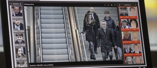 The screen of a computer with an automatic facial recognition system shows German Interior Minister Thomas de Maiziere (2ndR) walking down stairs as he visits the Suedkreuz train station where automatic facial recognition technologies are tested on December 15, 2017 in Berlin The screen of a computer with an automatic facial recognition system shows German Interior Minister Thomas de Maiziere (2ndR) walking down stairs as he visits the Suedkreuz train station where automatic facial recognition technologies are tested on December 15, 2017 in Berlin - Sputnik International