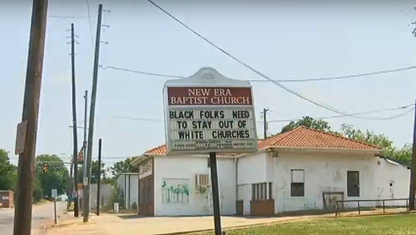 New Era Baptist Church in Birmingham, Alabama, with sign reading Black folks need to stay out of white churches and  White folks refused to be our neighbors, May 12, 2018 - Sputnik International