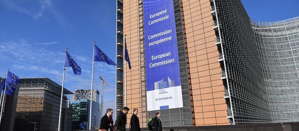 A picture taken on March 14, 2018 shows European Union flags next to the European Commission headquarters in Brussels, adorned by a banner displaying its name in French, amongst others European languages A picture taken on March 14, 2018 shows European Union flags next to the European Commission headquarters in Brussels, adorned by a banner displaying its name in French, amongst others European languages - Sputnik International