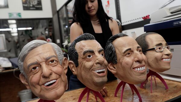 An employee moves masks of Leftist front-runner Andres Manuel Lopez Obrador of (MORENA), Ricardo Anaya, presidential candidate for the National Action Party (PAN), Institutional Revolutionary Party (PRI) presidential candidate Jose Antonio Meade and Independent presidential candidate Jaime Rodriguez are seen at a factory where the latex masks, in Cuernavaca, Mexico May 15, 2018 - Sputnik International