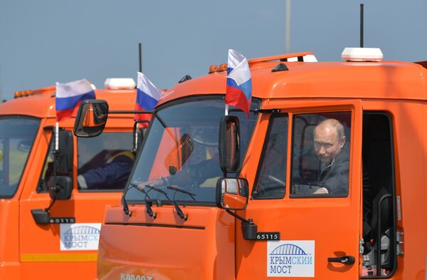 May 15, 2018. Russian President Vladimir Putin before driving a Kamaz truck on the newly opened motor road section of the Kerch Strait (Crimean) Bridge May 15, 2018. Russian President Vladimir Putin before driving a Kamaz truck on the newly opened motor road section of the Kerch Strait (Crimean) Bridge - Sputnik International