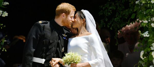 Prince Harry and Meghan Markle kiss on the steps of St George's Chapel in Windsor Castle after their wedding in Windsor, Britain, May 19, 2018 - Sputnik International