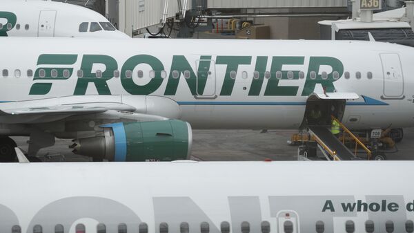 In this Monday, May 15, 2017, photograph, the company logo is showcased on the side of a Frontier Airlines airplane waiting at a gate on Concourse A in Denver International Airport in Denver - Sputnik International