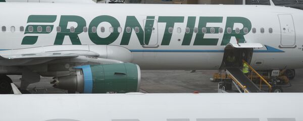 In this Monday, May 15, 2017, photograph, the company logo is showcased on the side of a Frontier Airlines airplane waiting at a gate on Concourse A in Denver International Airport in Denver - Sputnik International