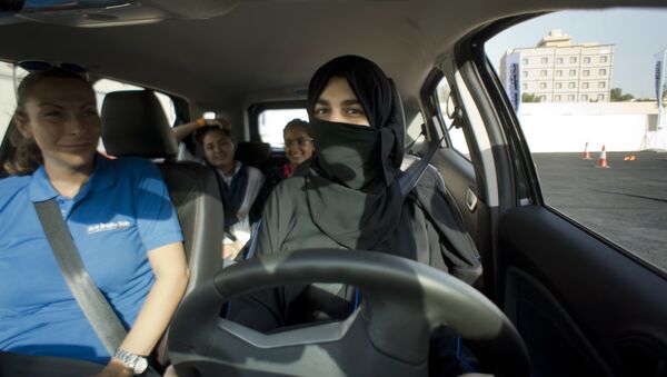 Razan, right, sits for the first time in the driver's seat, with her trainer Francesca Pardini, an Italian ex-race car driver, during training sponsored by Ford Motor, in Jiddah, Saudi Arabia, Tuesday, March 6, 2018. A stunning royal decree issued last year by King Salman announcing that women would be allowed to drive in 2018 upended one of the most visible forms of discrimination against women in Saudi Arabia. - Sputnik International