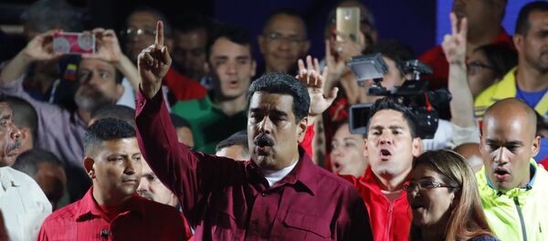 Venezuela's President Nicolas Maduro raises a finger as he is surrounded by supporters while speaking during a gathering after the results of the election were released, outside of the Miraflores Palace in Caracas, Venezuela, May 20, 2018 Venezuela's President Nicolas Maduro raises a finger as he is surrounded by supporters while speaking during a gathering after the results of the election were released, outside of the Miraflores Palace in Caracas, Venezuela, May 20, 2018 - Sputnik International