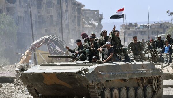 Service personnel of the Syrian Army on a BMD-1 in the liberated Palestinian refugee camp of Yarmouk south of Damascus - Sputnik International