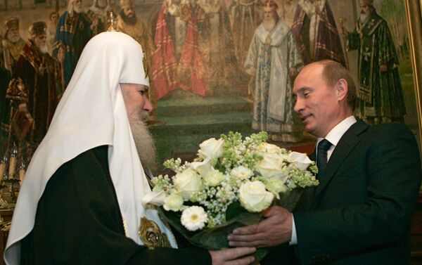 Vladimir Putin presents Patriarch Alexy II with a bouquet of flowers for his birthday. - Sputnik International