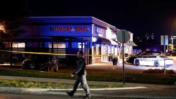A police officer walks in front of Bombay Bhel restaurant, where two unidentified men set off a bomb late Thursday night, wounding more than a dozen people, in Mississauga, Ontario, Canada May 25, 2018 - Sputnik International