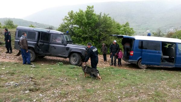 Albanian police officers detain Syrian migrants near the Albanian-Greek border near the city of Korca (File) - Sputnik International