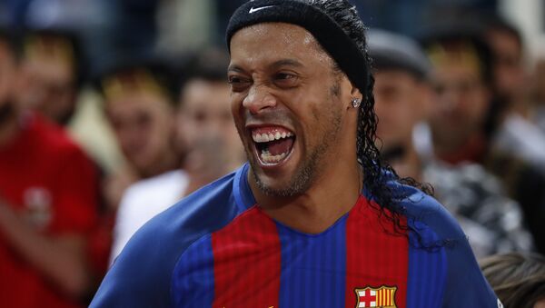 Former FC Barcelona player Ronaldinho, laughs as he enters the stadium during a friendly soccer match between the FC Barcelona and Real Madrid Legends, at the Camille Chamoun Sports City in Beirut, Lebanon, Friday,  - Sputnik International
