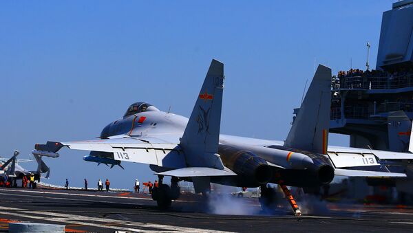 This photo taken on April 24, 2018 shows a J15 fighter jet landing on China's sole operational aircraft carrier, the Liaoning, during a drill at sea - Sputnik International