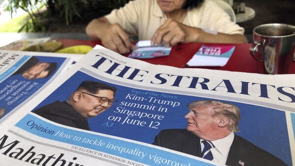 FILE - In this May 11, 2018, file photo, a news vendor counts her money near a stack of newspapers with a photo of U.S. President Donald Trump, right, and North Korea's leader Kim Jong Un on its front page in Singapore. - Sputnik International