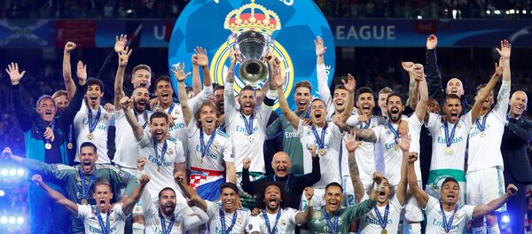 Soccer Football - Champions League Final - Real Madrid v Liverpool - NSC Olympic Stadium, Kiev, Ukraine - May 26, 2018 Real Madrid celebrate winning the Champions League with the trophy - Sputnik International