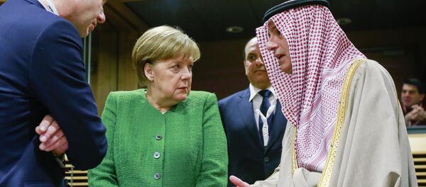 Germany's Chancellor Angela Merkel (C) speaks with Saudi-Arabia's Foreign Minister Adel al-Jubeir (R) as they arrive to attend a High Level Conference on the Sahel at the European Commission in Brussels on February 23, 2018 - Sputnik International