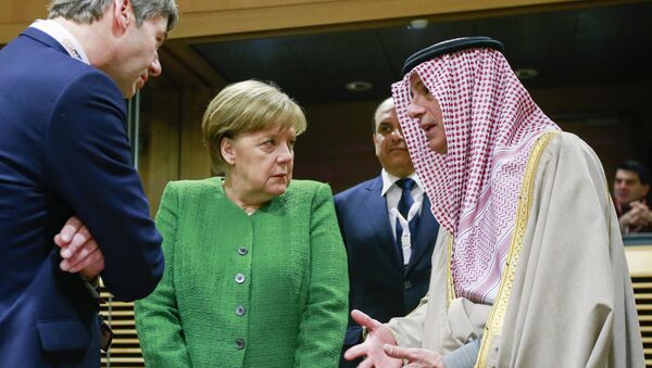 Germany's Chancellor Angela Merkel (C) speaks with Saudi-Arabia's Foreign Minister Adel al-Jubeir (R) as they arrive to attend a High Level Conference on the Sahel at the European Commission in Brussels on February 23, 2018 - Sputnik International